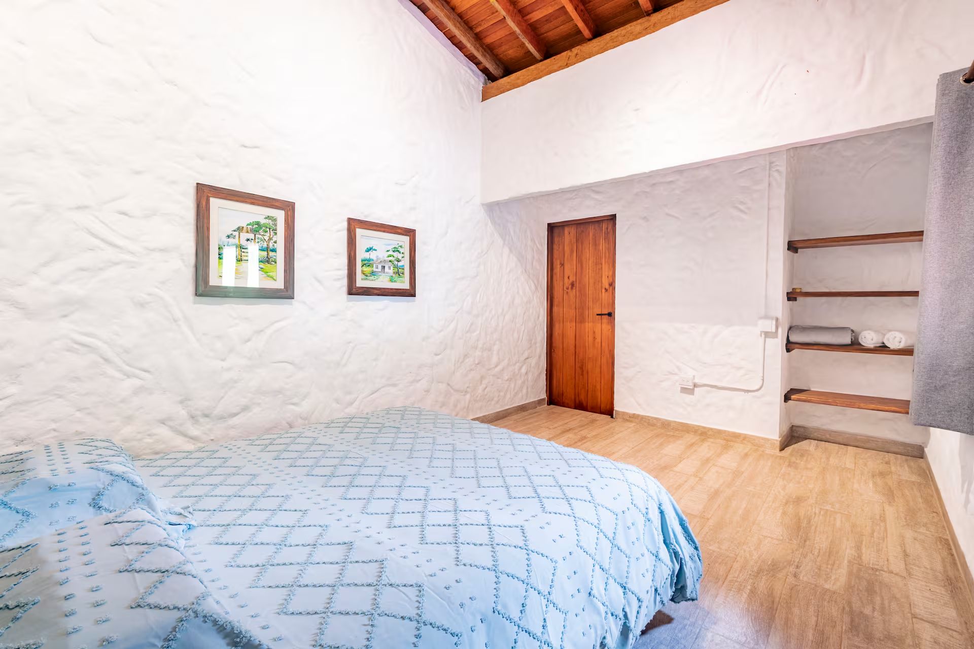 A side bedroom, white walls, watercolor of the valley